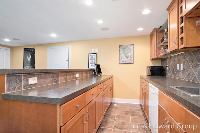 1003 Kusterer Dr NW, Grand Rapids, MI 49534 - kitchen with white dishwasher, dark countertops, backsplash, a peninsula, and open shelves