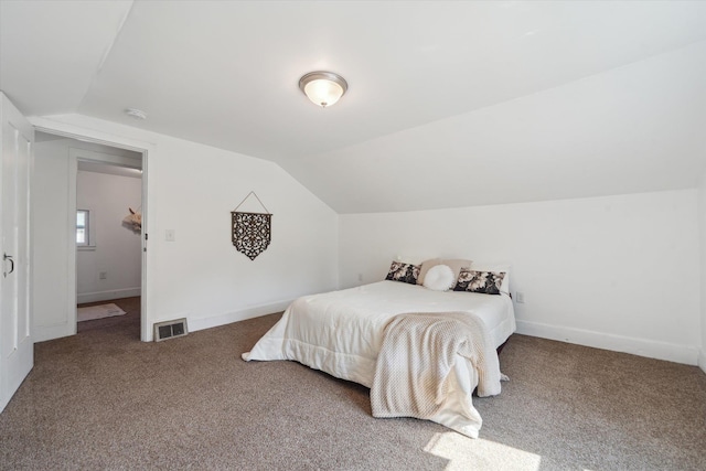 334 N Hickory St, Owosso, MI 48867 - carpeted bedroom featuring lofted ceiling and baseboards