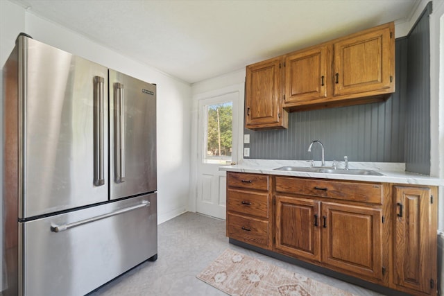 334 N Hickory St, Owosso, MI 48867 - kitchen with freestanding refrigerator, brown cabinetry, and light floors