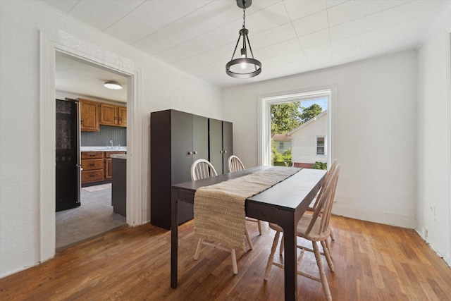 334 N Hickory St, Owosso, MI 48867 - dining area featuring light wood-style flooring and baseboards
