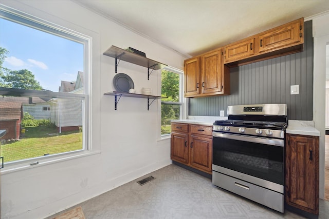 334 N Hickory St, Owosso, MI 48867 - kitchen featuring gas stove, light countertops, open shelves, and brown cabinetry