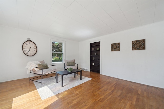 334 N Hickory St, Owosso, MI 48867 - living area featuring built in shelves and wood finished floors