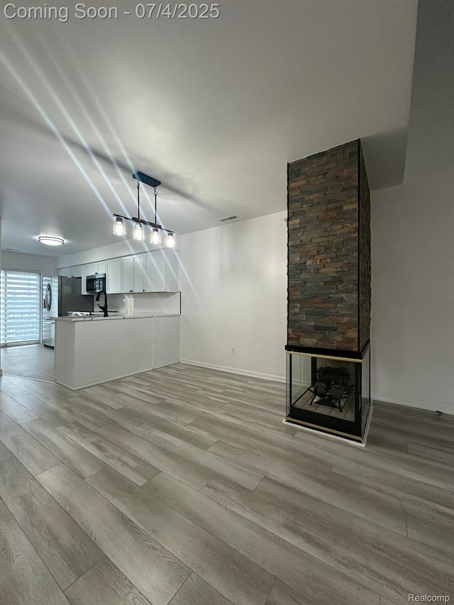 4248 Schaefer Rd, Dearborn, MI 48126 - unfurnished living room with light wood-style flooring and baseboards