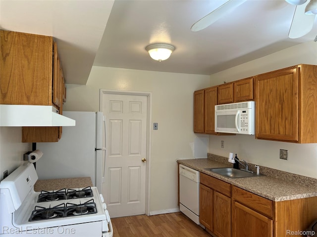 39728 Village Wood Cir, Novi, MI 48375 - kitchen featuring white appliances, under cabinet range hood, brown cabinetry, and light wood-type flooring