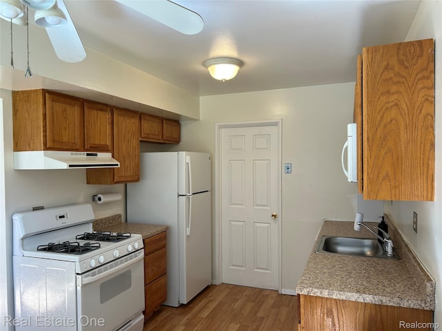 39728 Village Wood Cir, Novi, MI 48375 - kitchen with white appliances, under cabinet range hood, brown cabinetry, and light wood-style floors