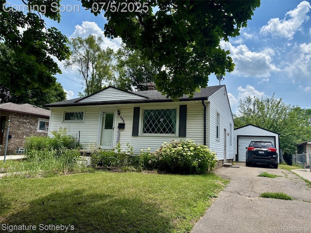 686 E Columbia Ave, Pontiac, MI 48340 - view of front of house featuring asphalt driveway, a front yard, a detached garage, and an outdoor structure