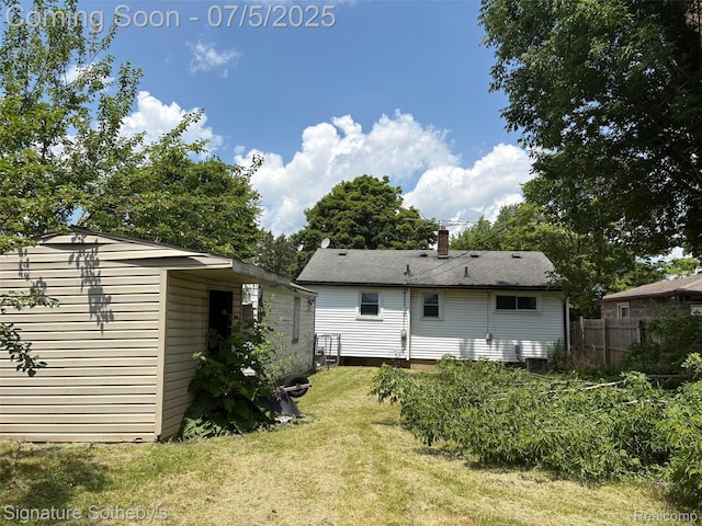 686 E Columbia Ave, Pontiac, MI 48340 - rear view of property with a chimney and an outdoor structure