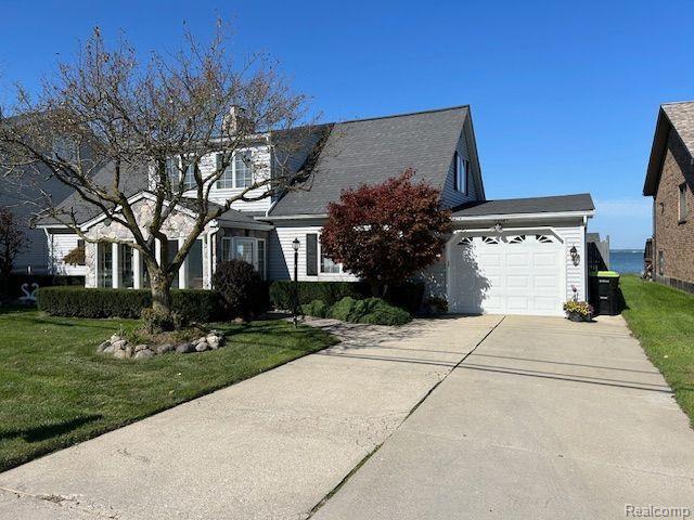 32241 N River Rd, Harrison Township, MI 48045 - view of front of property with concrete driveway, an attached garage, and a front yard