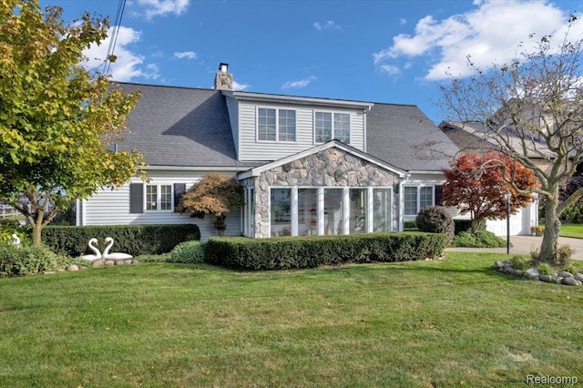 32241 N River Rd, Harrison Township, MI 48045 - rear view of house featuring stone siding, a yard, a chimney, and a garage