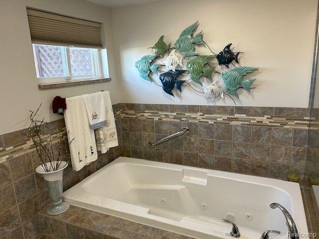 32241 N River Rd, Harrison Township, MI 48045 - bathroom with a jetted tub and tile walls