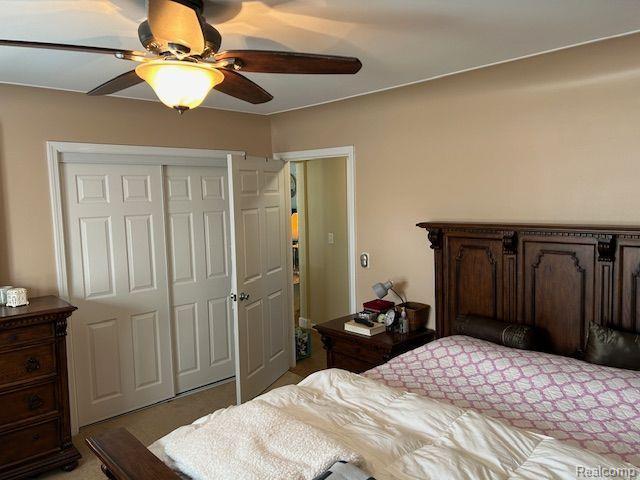 32241 N River Rd, Harrison Township, MI 48045 - bedroom featuring a closet, ceiling fan, and light carpet