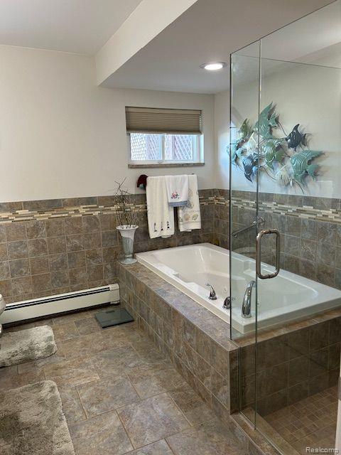 32241 N River Rd, Harrison Township, MI 48045 - full bath featuring a baseboard heating unit, a bath, a stall shower, and stone finish flooring