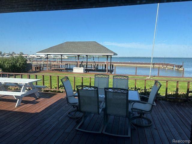 32241 N River Rd, Harrison Township, MI 48045 - wooden terrace featuring a water view, outdoor dining area, and a yard