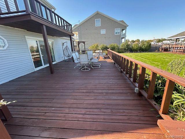 32241 N River Rd, Harrison Township, MI 48045 - wooden deck featuring outdoor dining space and a yard