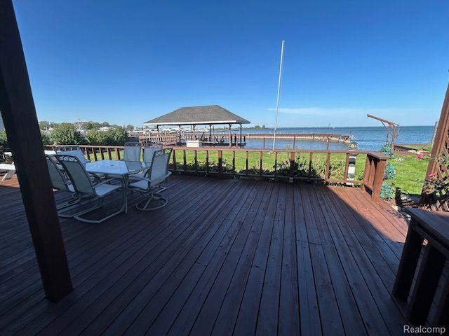 32241 N River Rd, Harrison Township, MI 48045 - wooden terrace with a water view and outdoor dining space