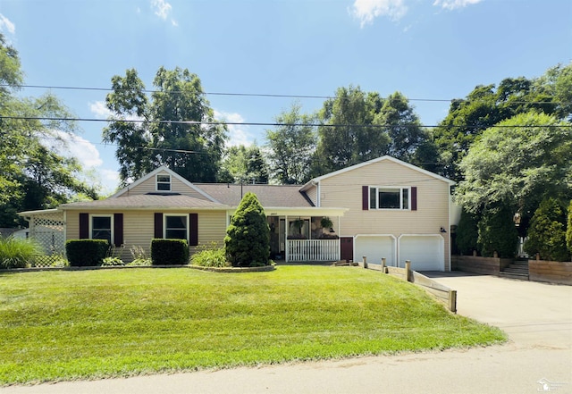 2911 Whitlock Rd, Jackson, MI 49202 - split level home featuring an attached garage, concrete driveway, and a front lawn