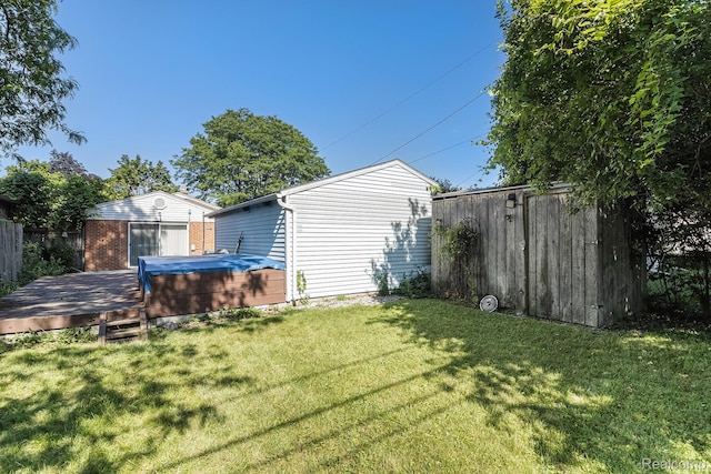 8476 Robindale Ave, Dearborn Heights, MI 48127 - view of yard with a hot tub, a deck, and an outbuilding