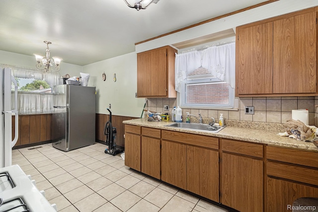 8476 Robindale Ave, Dearborn Heights, MI 48127 - kitchen with freestanding refrigerator, light countertops, light tile patterned floors, and a chandelier