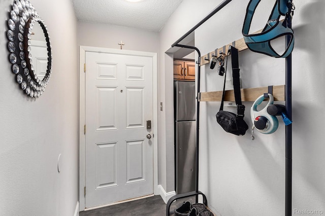 8150 24 Mile Rd, Shelby Twp, MI 48316 - doorway featuring a textured ceiling and dark wood finished floors