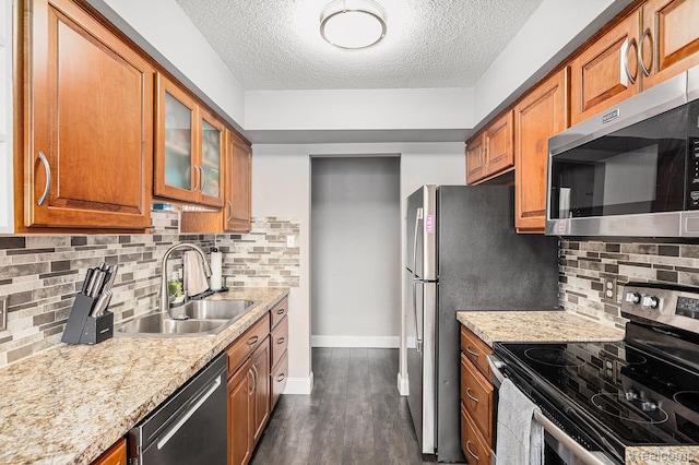 8150 24 Mile Rd, Shelby Twp, MI 48316 - kitchen featuring appliances with stainless steel finishes, brown cabinetry, a textured ceiling, dark wood finished floors, and backsplash