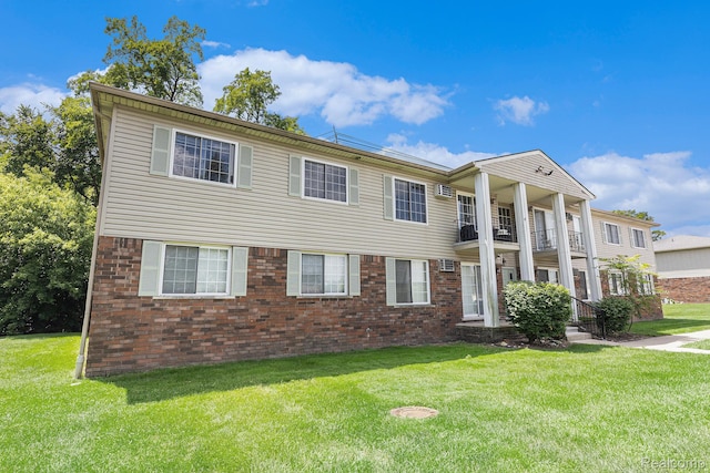8150 24 Mile Rd, Shelby Twp, MI 48316 - greek revival inspired property with a balcony, a front lawn, and brick siding