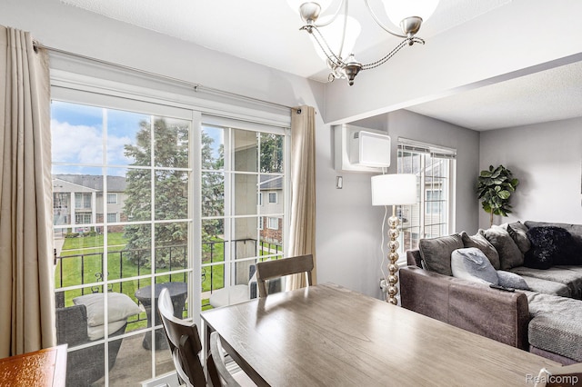 8150 24 Mile Rd, Shelby Twp, MI 48316 - dining space featuring a chandelier, healthy amount of natural light, and a wall mounted air conditioner