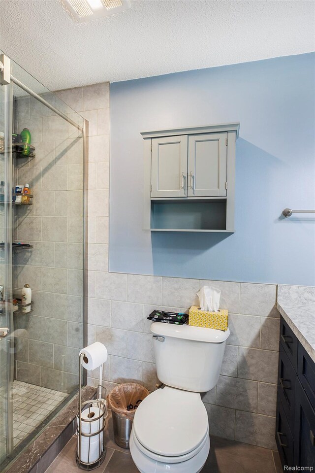 8150 24 Mile Rd, Shelby Twp, MI 48316 - bathroom with tile walls, a stall shower, vanity, wainscoting, and a textured ceiling