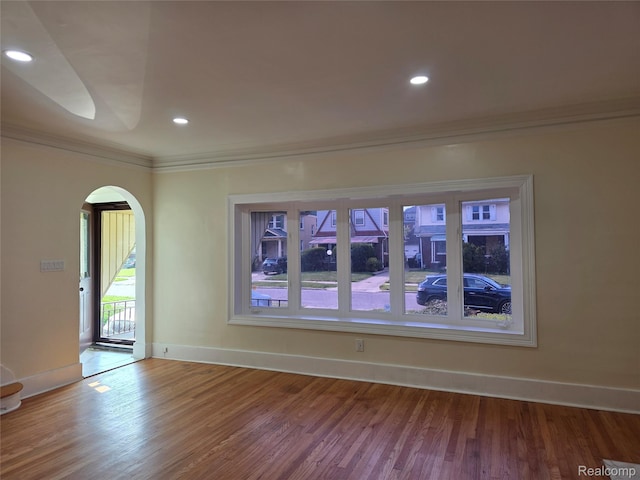 2681 Burlingame St, Detroit, MI 48206 - empty room with arched walkways, ornamental molding, wood finished floors, and recessed lighting