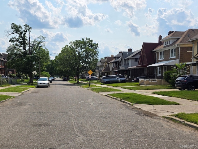 2681 Burlingame St, Detroit, MI 48206 - view of asphalt street with a residential view, sidewalks, traffic signs, and curbs