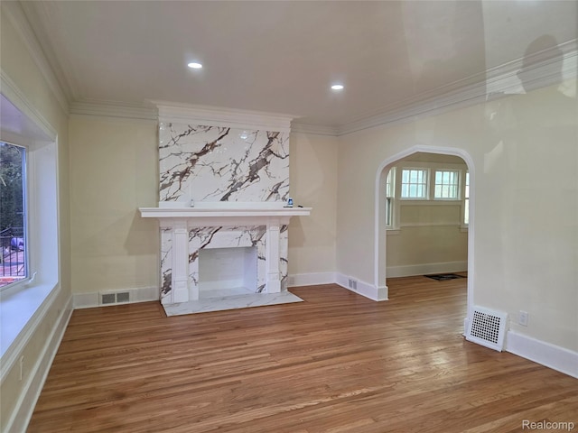 2681 Burlingame St, Detroit, MI 48206 - unfurnished living room with ornamental molding, arched walkways, wood finished floors, a premium fireplace, and recessed lighting