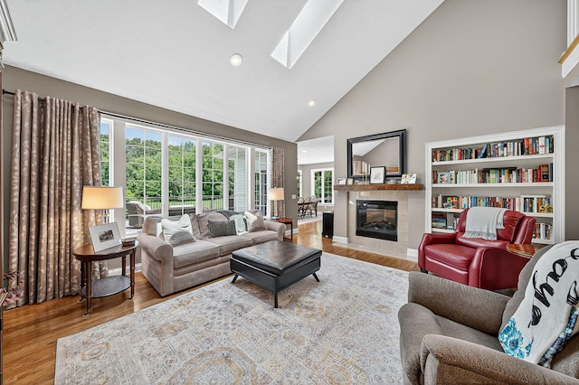 29750 Edwards Way, Niles, MI 49120 - living room with wood finished floors, a skylight, high vaulted ceiling, a fireplace, and recessed lighting
