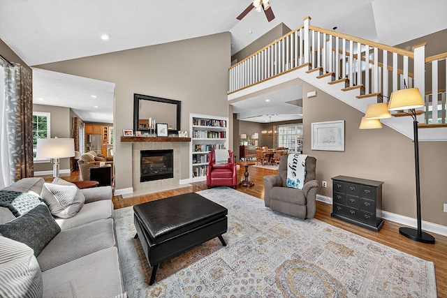 29750 Edwards Way, Niles, MI 49120 - living area featuring a ceiling fan, wood finished floors, high vaulted ceiling, a fireplace, and stairs