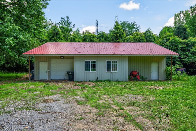 29750 Edwards Way, Niles, MI 49120 - back of property with a metal roof, driveway, a detached garage, and board and batten siding