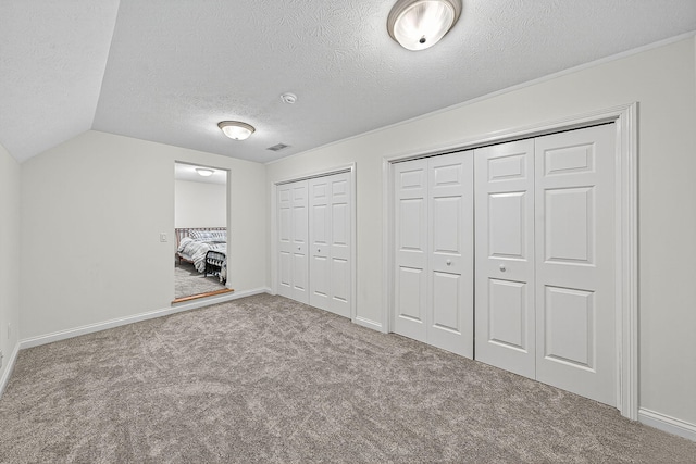 29750 Edwards Way, Niles, MI 49120 - unfurnished bedroom featuring carpet floors, two closets, a textured ceiling, and vaulted ceiling