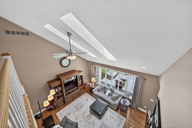 29750 Edwards Way, Niles, MI 49120 - living room featuring a skylight, a textured ceiling, ceiling fan, wood finished floors, and lofted ceiling