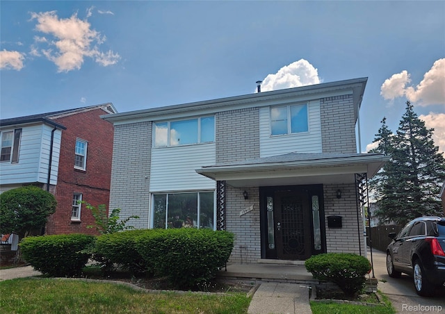 18410 Marlowe St, Detroit, MI 48235 - view of front facade with brick siding and a porch