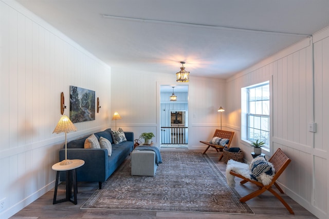 457 N Garfield, Traverse City, MI 49696 - living room featuring wood finished floors, a decorative wall, and a chandelier