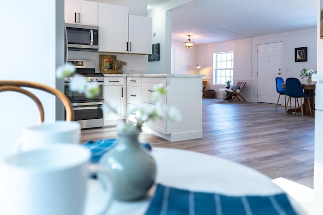 457 N Garfield, Traverse City, MI 49696 - kitchen with appliances with stainless steel finishes, white cabinetry, light countertops, and light wood-style floors