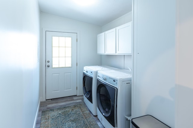 457 N Garfield, Traverse City, MI 49696 - laundry room with washer and dryer, cabinet space, and light wood-type flooring