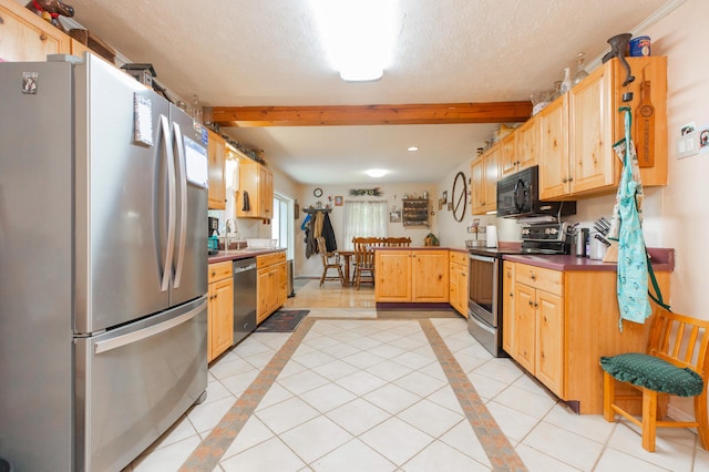 2314 Hand Rd, Niles, MI 49120 - kitchen with appliances with stainless steel finishes, inlaid floor details, beamed ceiling, a peninsula, and a textured ceiling