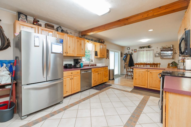 2314 Hand Rd, Niles, MI 49120 - kitchen with stainless steel appliances, inlaid floor details, dark countertops, recessed lighting, and light tile patterned floors
