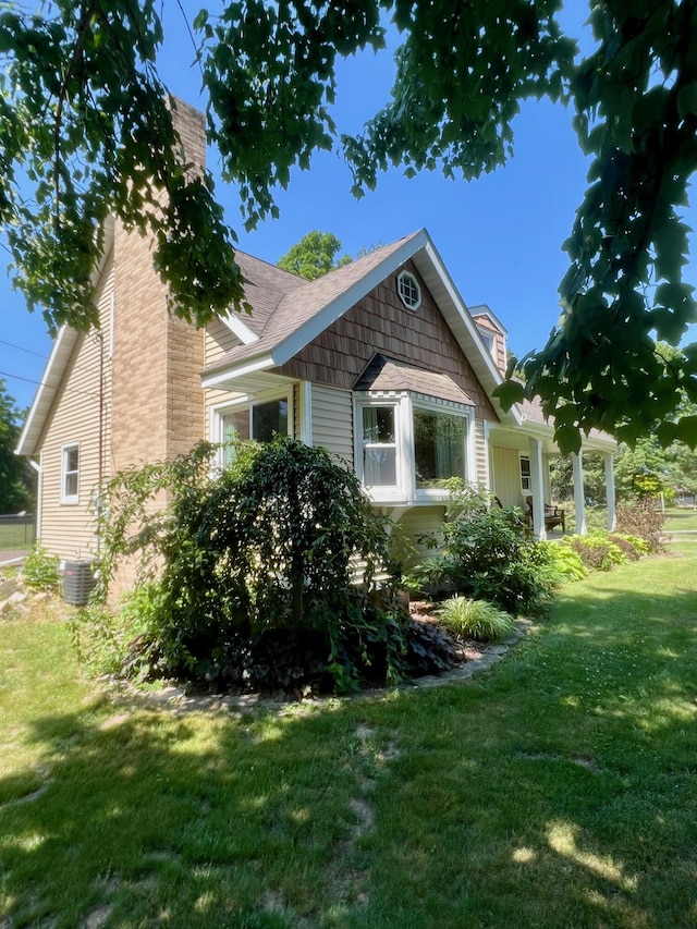 7220 W 64th St, Fremont, MI 49412 - view of property exterior with a yard and a chimney