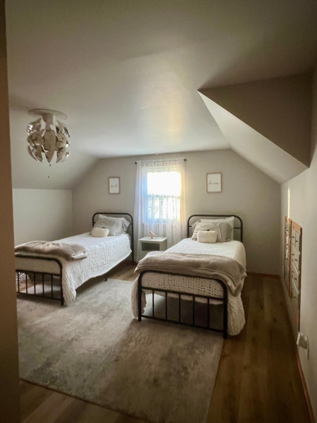 7220 W 64th St, Fremont, MI 49412 - bedroom featuring wood finished floors and vaulted ceiling