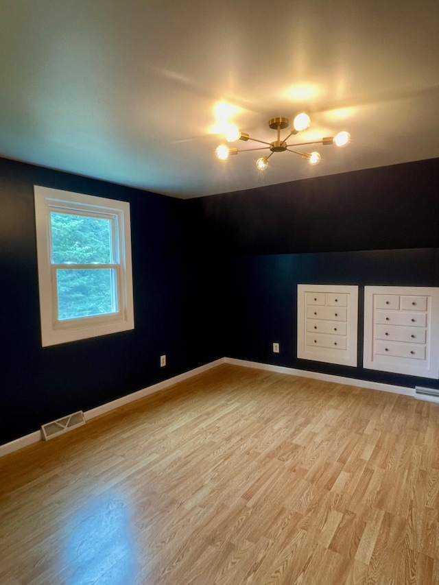 7220 W 64th St, Fremont, MI 49412 - unfurnished room featuring a chandelier and light wood-type flooring