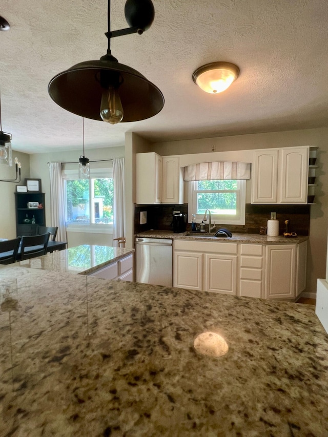 7220 W 64th St, Fremont, MI 49412 - kitchen with dishwasher, a textured ceiling, light stone countertops, white cabinets, and pendant lighting