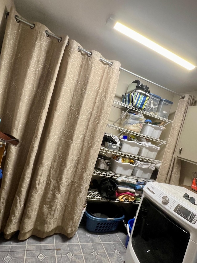 7220 W 64th St, Fremont, MI 49412 - bathroom with washer / clothes dryer, tile patterned flooring, and curtained shower