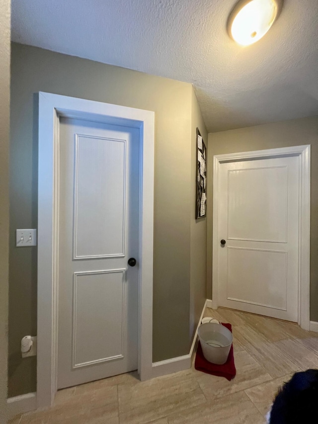 7220 W 64th St, Fremont, MI 49412 - hallway with baseboards and a textured ceiling