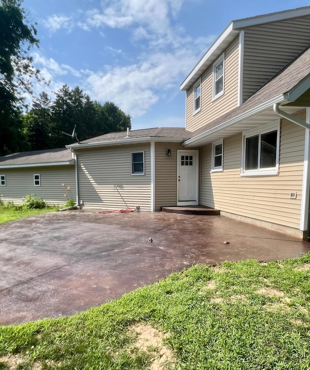 7220 W 64th St, Fremont, MI 49412 - rear view of property featuring a patio area and roof with shingles