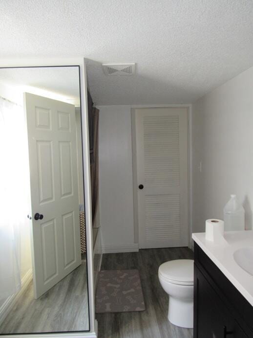 168 Fremont St, Bronson, MI 49028 - full bath with wood finished floors, a textured ceiling, and vanity