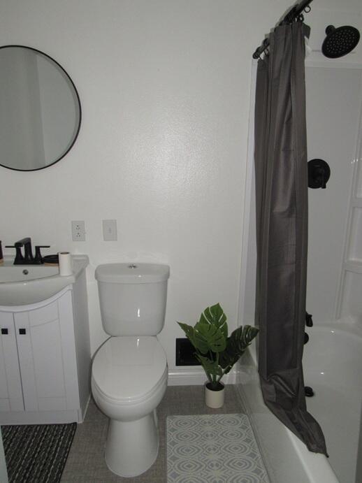 168 Fremont St, Bronson, MI 49028 - full bath featuring vanity, tile patterned floors, and shower / tub combo with curtain